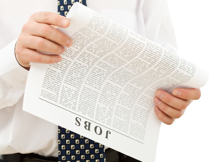 Job seeker looking at a newspaper